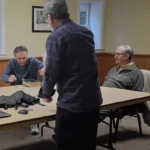Men gathering for a Bible study around a table