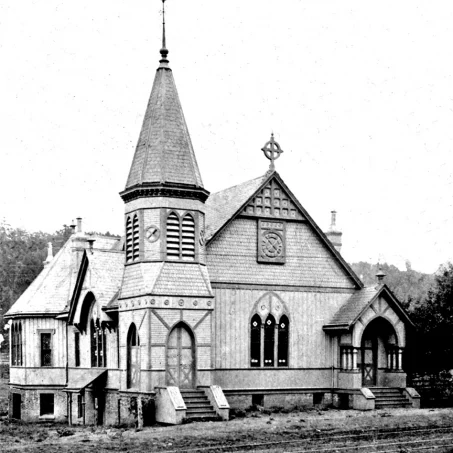 An old black and white photo of St Elmo Presbyterian Church from 1890-1893, approximately. Dirt road in front with trolley lines.