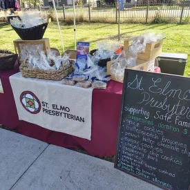 Table filled with baked goods for the neighborhood feast day in St Elmo. Goods sold benefit the Safe Families organization in Chattanooga.
